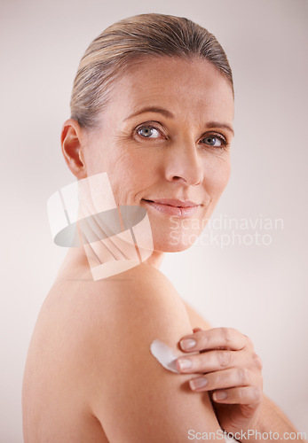 Image of Mature woman, cream and studio with treatment, portrait and cosmetic with skincare. Model, beauty and luxury with body, cosmetics and care for anti ageing and healthy skin for wellness and confidence