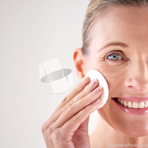 Image of Senior woman, portrait or cotton for beauty in studio with facial cleansing, cosmetics or mockup space. Model, person or swab for face detox, makeup removal or anti aging skincare on white background