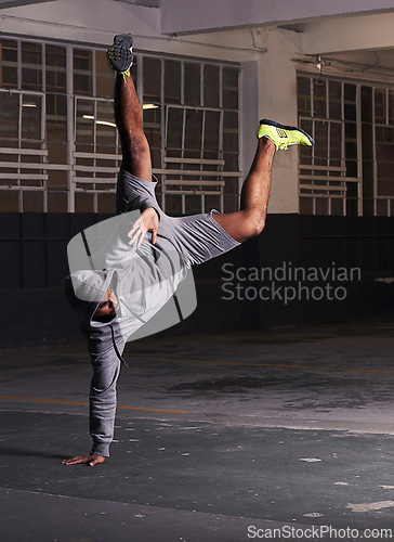 Image of Breakdance, man and handstand with fitness outdoor for training, practice and workout in warehouse. Dancer, street dance and hip hop dancing in building with performance, stunt and flexible movement