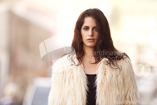 Image of Portrait, woman and fashion in confidence in city outdoor, winter and cold weather with street wear and downtown New York. Female person, style and trendy clothes or outfit and fur jacket for trends