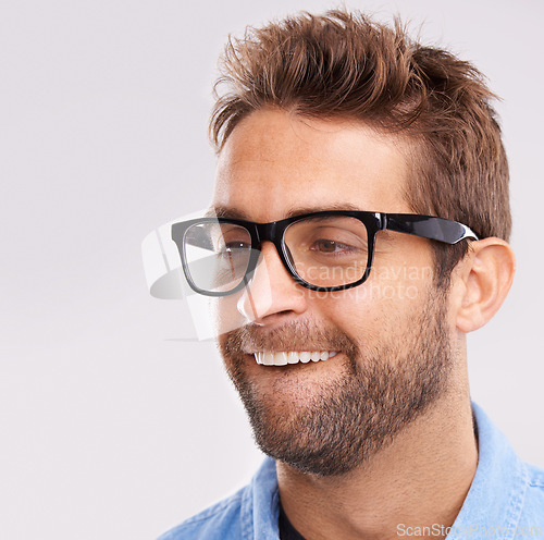 Image of Silly face, nerd and man with glasses, happiness and facial expression on a grey studio background. Model, eyewear and person with goofy guy and reaction with character and quirky with comedy or joke