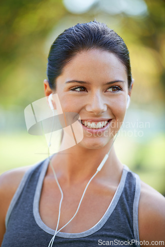 Image of Woman, earphones and music for exercise in park, closeup and audio inspiration for training in marathon race. Young lady, happy or streaming radio for fitness, commitment or morning workout in nature