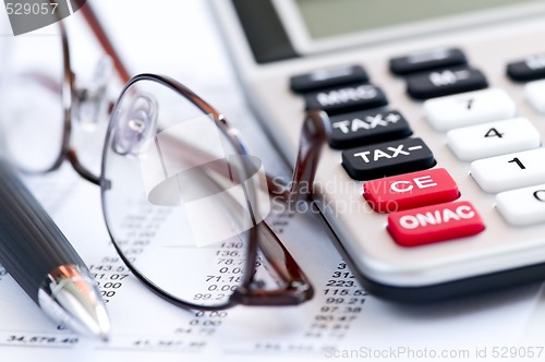 Image of Tax calculator pen and glasses