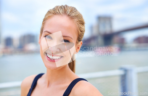 Image of Woman, happy and smile portrait in city, holiday and tourist with attractive female person in New York. Blue sky, traveling in summer in urban area, relaxing vacation and outdoor wellness by river