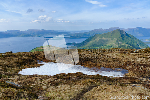 Image of Serene highland vista overlooking a crystalline fjord amidst mou