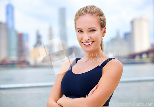 Image of Exercise, portrait and woman with arms crossed for training, morning workout or running competition in city. Smile, wellness and face of female person for cardio, health and confidence in New York