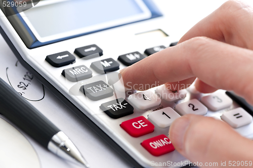 Image of Tax calculator and pen