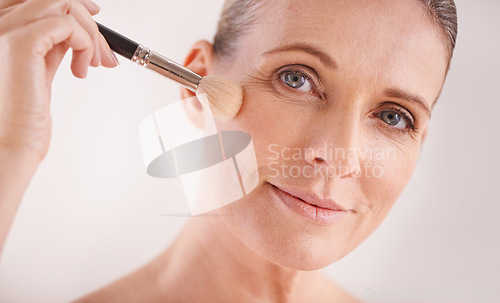 Image of Makeup brush, face and portrait of woman in studio for cosmetic, self care and facial glow routine. Beauty, foundation and mature female person with cosmetology tool for treatment by white background