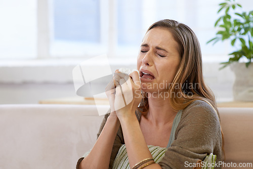 Image of Woman, crying and emotional distress in home with mental health, depression or broken heart. Female person, tissue and tears in apartment or psychology grief or suffering for worry, loneliness or sad