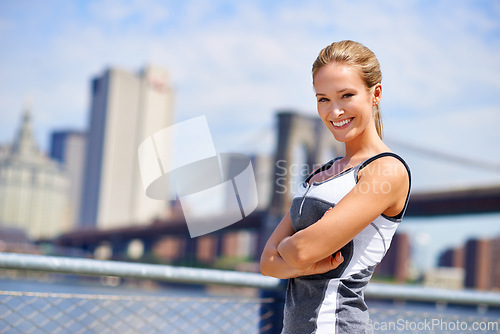 Image of Woman, portrait and confident in city for fitness morning routine, wellness and exercise for active cardio. Female person, happy and runner or athlete for sports hobby or training workout in New York