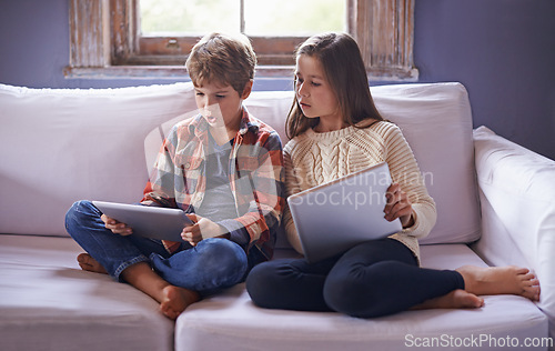 Image of Boy, girl and tablet for gaming on couch together, technology and online streaming for bonding at home. Digital .world, internet with kids or sibling in living room, gamer app or elearning with ebook