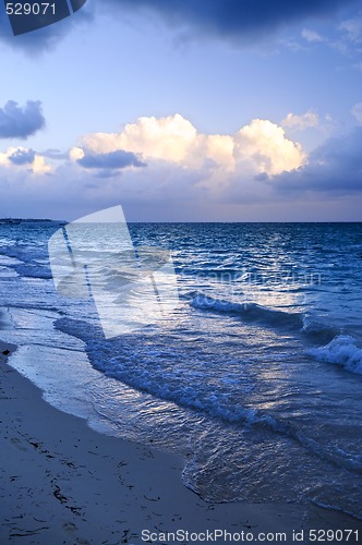 Image of Ocean waves on beach at dusk