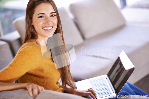 Image of Portrait, home and woman with a laptop, smile and relax with connection and internet in a lounge. Face, apartment and girl on a couch and person with computer and website information with technology