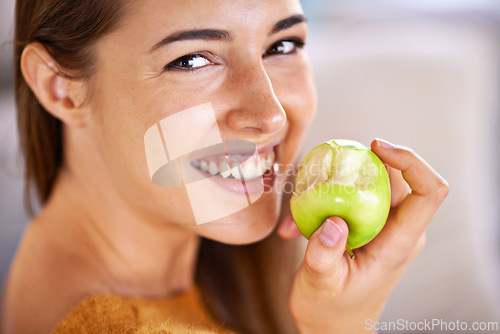 Image of Woman, portrait and apple for hunger in home, organic fiber and fruit for wellness. Happy female person, vitamins and minerals for healthy living, eating snack and vegan food in closeup for diet