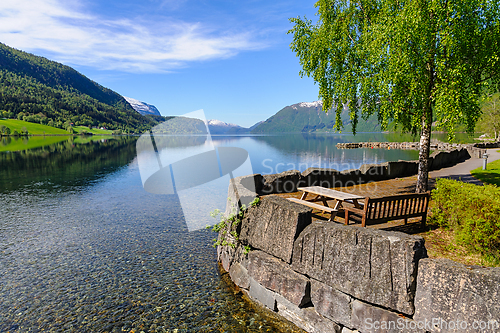 Image of Serene picnic spot by pristine lake in norwegian mountains, spri