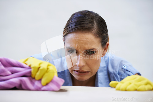 Image of Woman, gloves and cleaning table in home, disinfection and remove dirt or bacteria for maintenance. Female person, housekeeeping and wash with detergent or sanitation, maid and chemical for germs