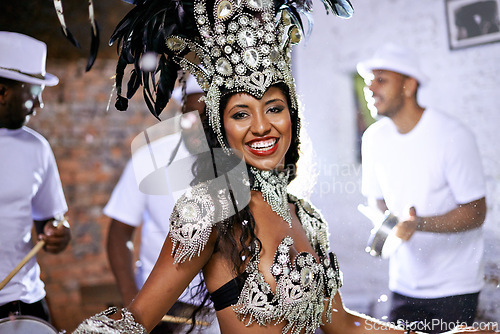 Image of Portrait, happy woman and dancing at carnival with band for performance, party or celebration. Face, samba and Brazilian person at music festival in feather costume, makeup and smile at concert event