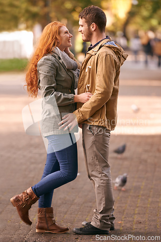 Image of Couple, love and smile with date at park in cold weather or winter, together and support in London. Relationship, commitment and bonding for romance with soulmate, care and happiness for affection