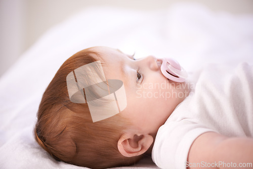 Image of Baby, pacifier and relax on bed in home for with wellness, quiet and rest in morning in nursery. Infant, newborn and peace with soother, growth and closeup for childhood development in family house