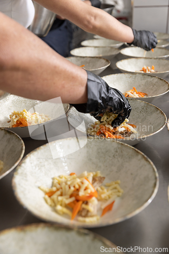 Image of Professional chef plating food