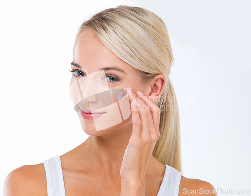 Image of Woman, portrait and skincare lotion in studio or moisturizer wellness with dermatology, product or white background. Female person, cream and facial sunscreen or self care, protection or mockup space