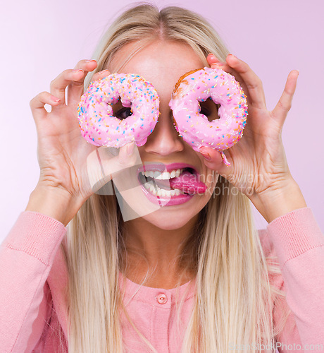 Image of Donut, silly and portrait in studio for dessert, frosting and pink for sprinkles and sweet for sugar and crazy. Young person with tongue out for funny, comic and pastry for cake and icing for color