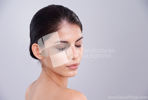 Image of Beauty, skincare and woman with eyes closed in studio, clean and natural with cosmetic care and wellness on grey background. Facial, treatment and dermatology, peace with healthy skin and shine