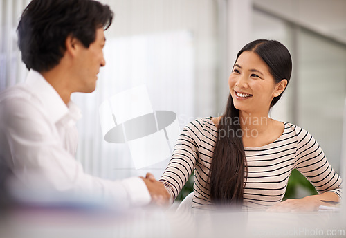 Image of Happy, business people and handshake with colleague for agreement, meeting or deal together at the office. Man and woman with smile and shaking hands for b2b, greeting or partnership at the workplace