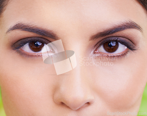 Image of Woman, portrait and eye vision with makeup, cosmetics and skincare with plant and green background. Wellness, care and facial treatment with female person and eyecare with dermatology and skin glow