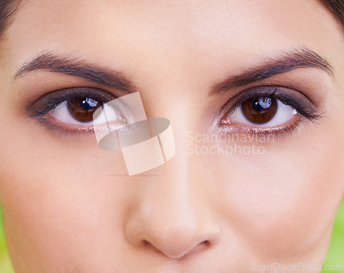 Image of Woman, portrait and eye vision with makeup, cosmetics and skincare with plant and green background. Wellness, care and facial treatment with female person and eyecare with dermatology and skin glow