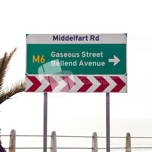 Image of Road sign, intersection and direction in city with arrow for grammar, mistake or text for gas for driving in neighborhood. Buildings, error and funny signage with joke, fart and warning in Cape Town