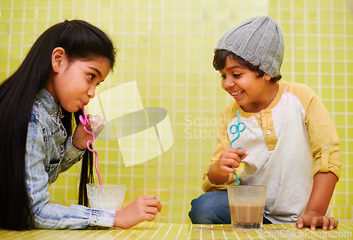 Image of Children, fun and siblings on a floor with milk, chocolate or smoothie games, challenge or drinking competition at home. Love, family and children bonding with liquid contest in house with milkshake