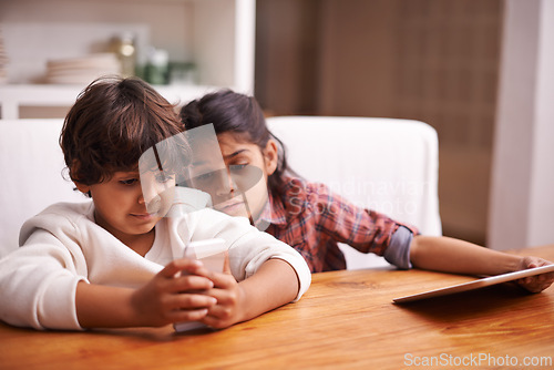 Image of Phone, search and kid siblings with tablet in a kitchen for google it, gaming or bonding at home. Family, subscription and children in a house with online service, sign up or vacation entertainment