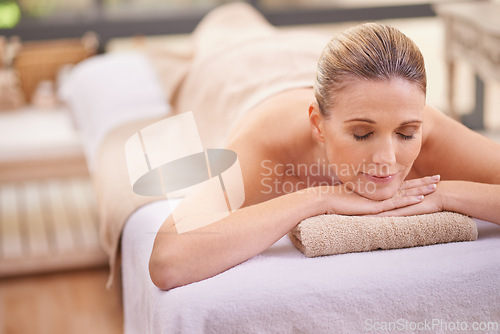 Image of Woman, massage or relax in holistic, peace or luxury as beauty therapy, self care or wellness at spa. Table, towel or zen in rest, detox or balance at cosmetology, clinic or skincare retreat in Dubai