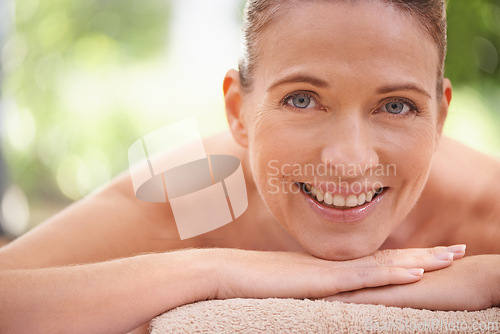 Image of Closeup, portrait or woman to relax, massage or spa as luxury, self care or wellness on zen table. Beauty, therapy or smile in mental health, detox or balance as skin, glow or bed on holistic retreat