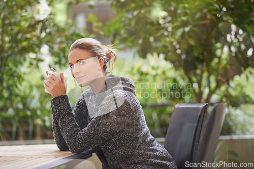 Image of Portrait, table and woman drinking coffee outdoor to relax, peace or calm in nature. Face, tea cup or person with hot beverage, espresso or latte for breakfast in the morning at garden of coffee shop