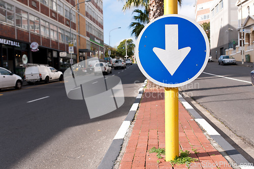 Image of Road sign, blue arrow and signage in street for direction with attention notification and symbol outdoor in city. Board, public notice and signpost for driver, alert message and advertisement in town