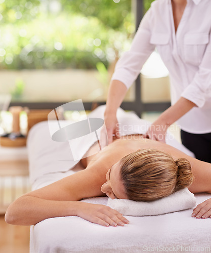 Image of Woman, hands and spa with massage therapist for luxury peace or stress relief at zen resort, calm or vacation. Female person, eyes closed and comfortable for healthy skincare, treatment or wellness