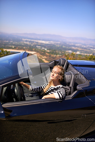 Image of Woman, relax and drive in sports car for road trip in summer or adventure on vacation in Beverly Hills. Luxury vehicle for speed on highway, transportation and mountain for journey or freedom.