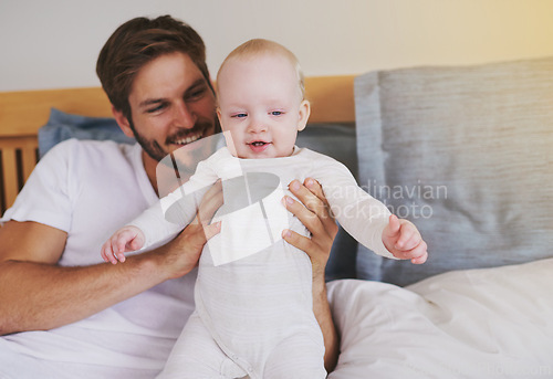 Image of Family, love and father with baby in bedroom for bonding, relationship and care for parenting. Happy, home and dad playing with newborn infant for child development, support and affection in house