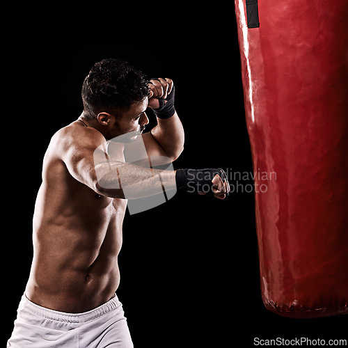 Image of Boxing, man and workout in studio with punching bag for training, exercise or competition fight with fitness. Athlete, boxer and power for martial arts with performance or topless on black background