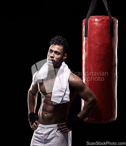 Image of Tired, boxer and man with towel in studio with gloves for training with strength and muscle. Adult, athlete and male person in dark background, healthy and power with body, punching bag and sport