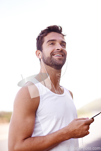 Image of Man, earphones and phone on road for running, music and motivation for cardio or training for marathon. Person, streaming and fitness on mountain for performance, athlete and playlist for exercise