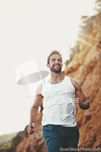 Image of Man, runner and athlete for outdoor workout, sports and nature for cardio or training for marathon. Male person, happy and fitness on mountain for performance challenge, health and exercise for race