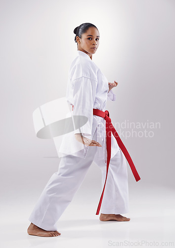 Image of Woman, portrait and karate fitness in studio, warrior and martial arts on white background. Black person, athlete and red belt for taekwondo, discipline and warrior ready for self defense or battle