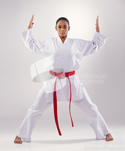 Image of Woman, portrait and hands for karate in studio, fitness and martial arts on white background. Black person, athlete and red belt for taekwondo, discipline and warrior ready for self defense or battle