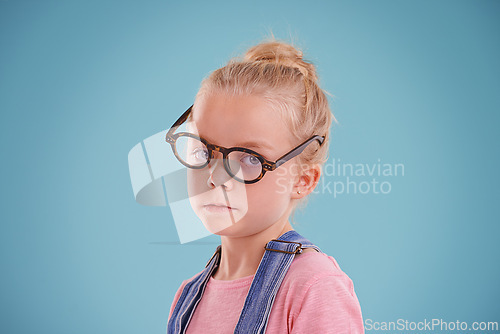 Image of Child, portrait and eye glasses vision in studio for optometry healthcare for youth development, blue background or mockup space. Female person, kid and eyewear for spectacle frame, sight or lens