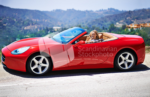 Image of Woman, red sports car and road trip on weekend, travel and luxury transport on summer drive. Happy female person, holiday and countryside wellness on mountain, vacation and adventure in vehicle