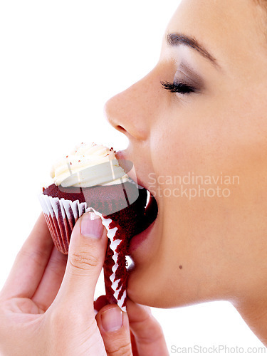 Image of Studio, woman and eating cupcake with happiness for nutrition, satisfaction and unhealthy snack. Female person, food and sweet dessert with red velvet, enjoyment and tasty muffin on white background