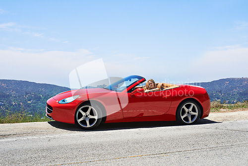 Image of Woman, red convertible and road trip on mountain, travel and luxury transport on summer drive. Happy female person, holiday and countryside wellness on street, vacation and adventure in vehicle